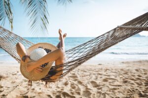 Woman in hammock by the beach