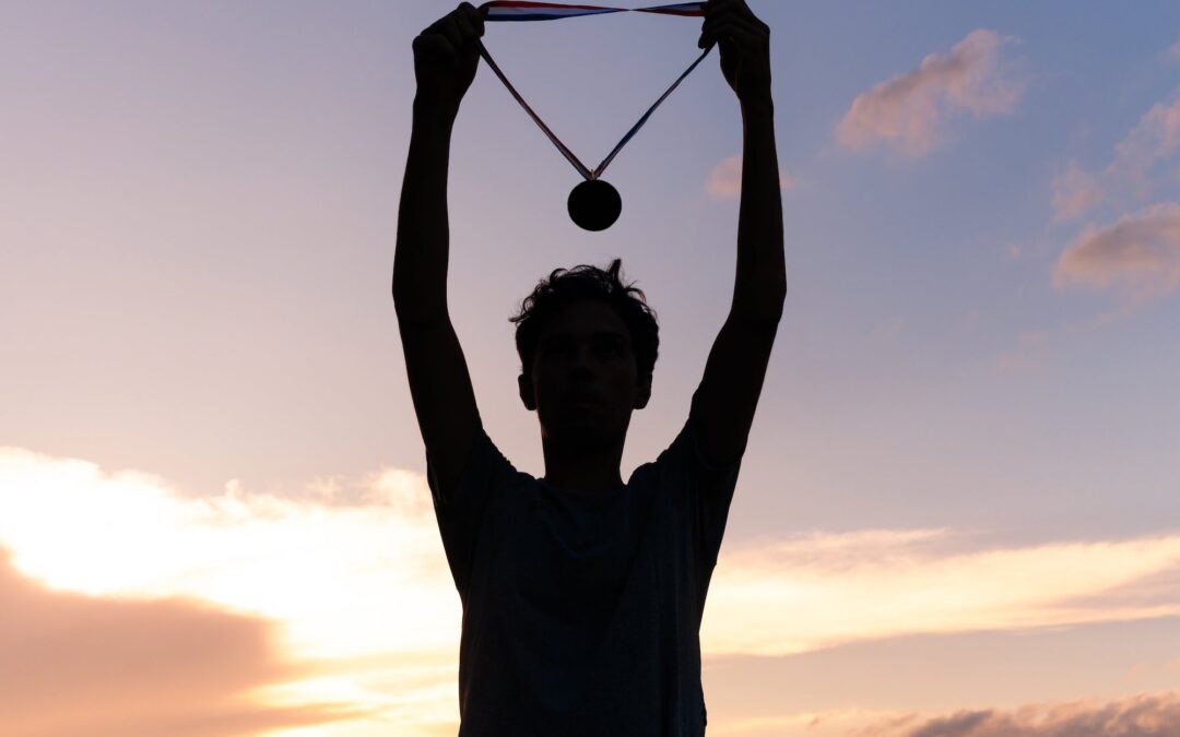 Person holding a medal in silhouette