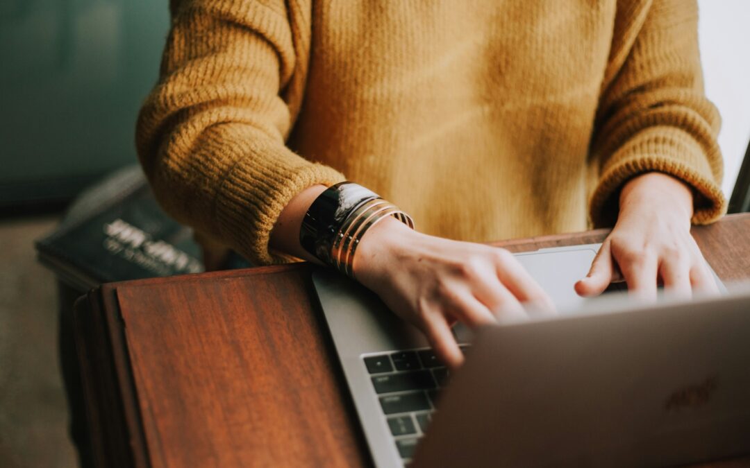 Person typing on a laptop computer.