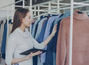Business woman with clothes rack